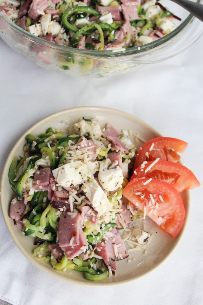The perfect side dish to go along with your Italian Meal, or even to be eaten on its own! Loaded with the flavors of parmesan, ham, mozzarella, and italian seasoning, then finished off with the zip of vinegar.  This Keto Antipasto Bowl requires no special ingredients and comes together in under 5 minutes.