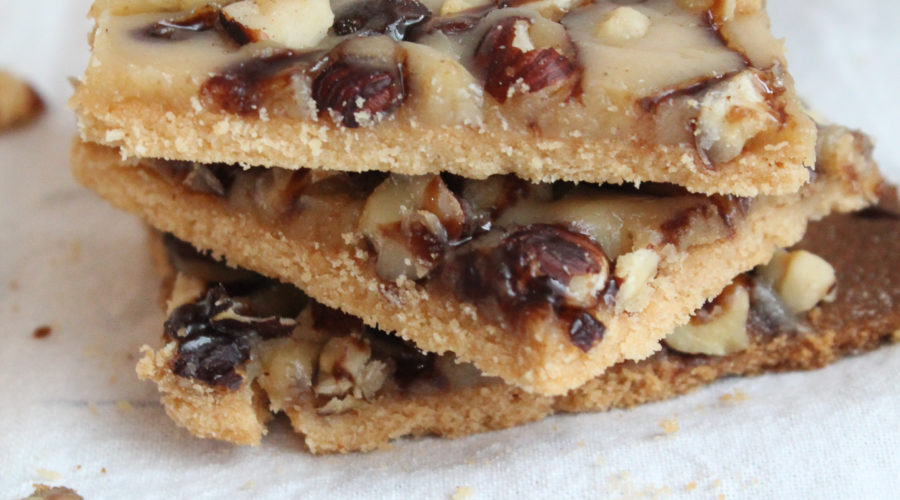 These Keto Shortbread cookies are layered with caramel and hazelnuts for the ultimate low-carb treat.  This recipe is included in my Complete Keto Holiday Cookbook, which is free, and releases 10/15/2018.