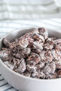 An easy, healthy, Keto Puppy Chow Recipe {Keto Muddy Buddies} that uses ingredients you probably already have in your Keto kitchen!  With crunchy cereal bits coated in peanut butter, chocolate, and then powdered sweetener, this will satisfy any sweet craving you have!