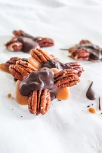 Keto Turtles that are made with perfectly chewy keto caramel, stevia sweetened chocolate, and delicious pecans!  These candies will fool even your non-keto family and friends and are sure to be a hit!