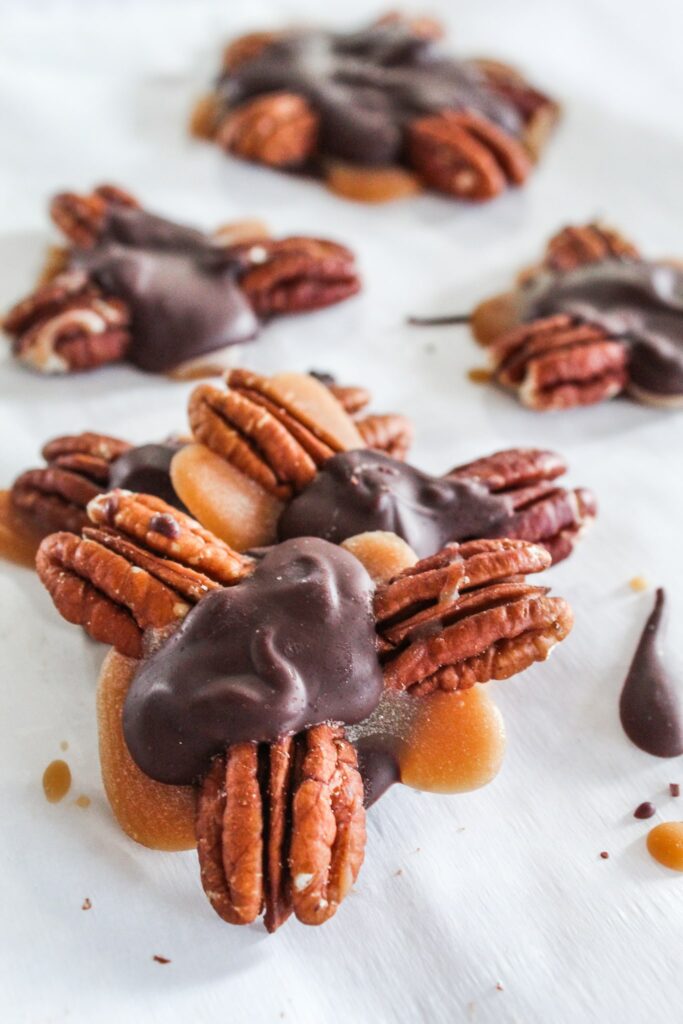 Keto Turtles that are made with perfectly chewy keto caramel, stevia sweetened chocolate, and delicious pecans!  These candies will fool even your non-keto family and friends and are sure to be a hit!