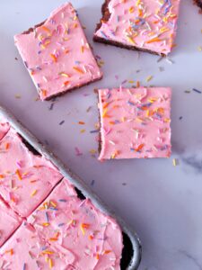 Soft, thick, and fluffy Keto Sugar Cookie Bars topped with a smooth, sweet frosting and sprinkles.  Baked in a sheet pan, these Keto Sugar Cookie Bars are great for a crowd!