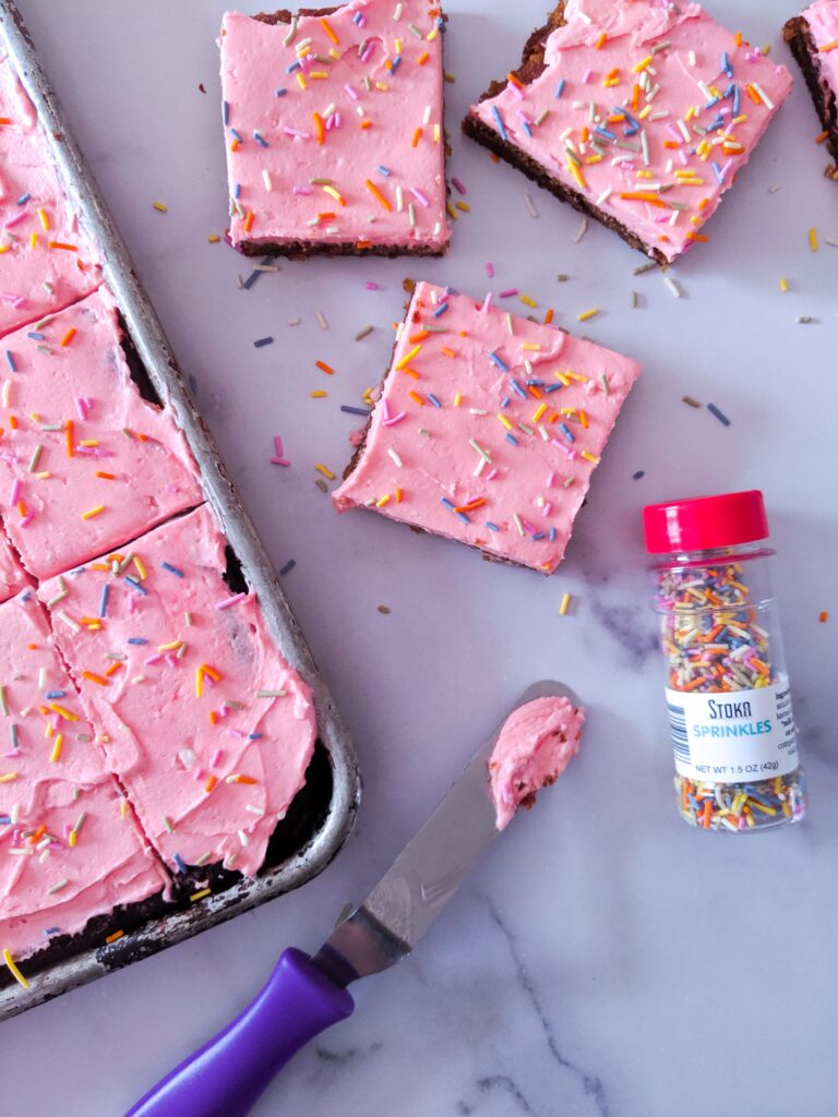 Soft, thick, and fluffy Keto Sugar Cookie Bars topped with a smooth, sweet frosting and sprinkles.  Baked in a sheet pan, these Keto Sugar Cookie Bars are great for a crowd!