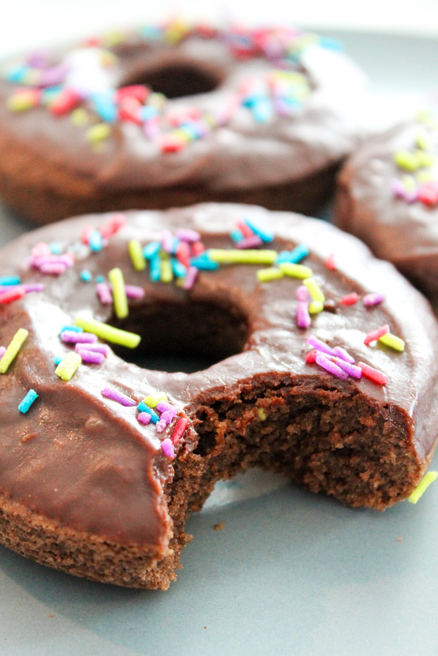 An easy to make Keto Chocolate Donut recipe.  Perfectly tender, with chocolate fudge icing - and even sprinkles! Keto Chocolate Donuts are delicious fresh out of the oven with a cup of coffee, or stored in the fridge and then reheated for 10 seconds in the microwave.
