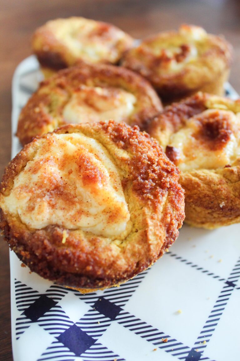 Cream cheese and pumpkin pie spice swirled in moist muffins and topped with cinnamon sugar streusel topping.  Keto Pumpkin Cream Cheese Muffins are a delicious fall breakfast or afternoon stack - great with a cup of pumpkin cream cold brew!