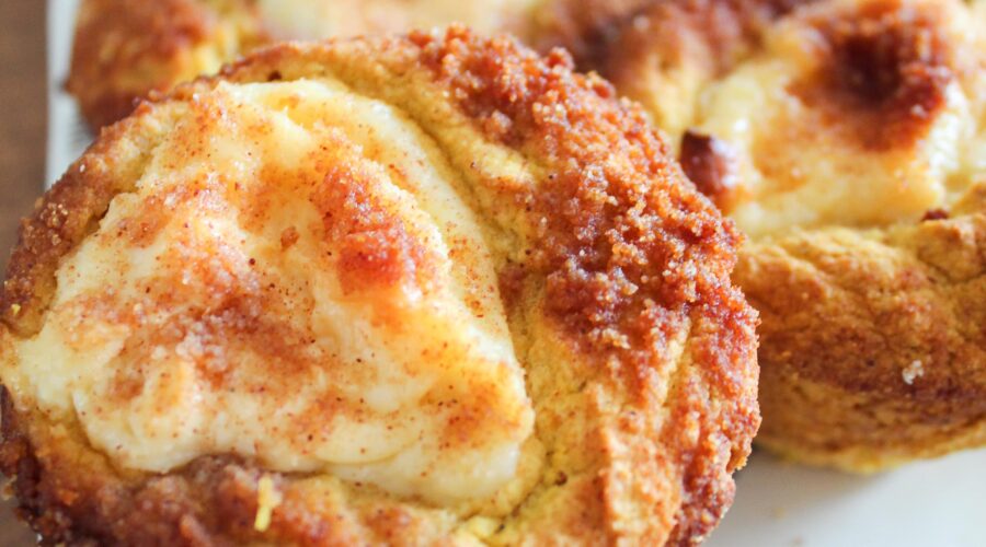 Cream cheese and pumpkin pie spice swirled in moist muffins and topped with cinnamon sugar streusel topping.  Keto Pumpkin Cream Cheese Muffins are a delicious fall breakfast or afternoon stack - great with a cup of pumpkin cream cold brew!