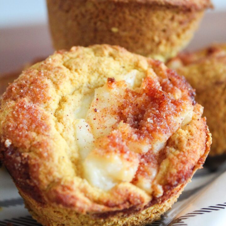 Cream cheese and pumpkin pie spice swirled in moist muffins and topped with cinnamon sugar streusel topping.  Keto Pumpkin Cream Cheese Muffins are a delicious fall breakfast or afternoon stack - great with a cup of pumpkin cream cold brew!