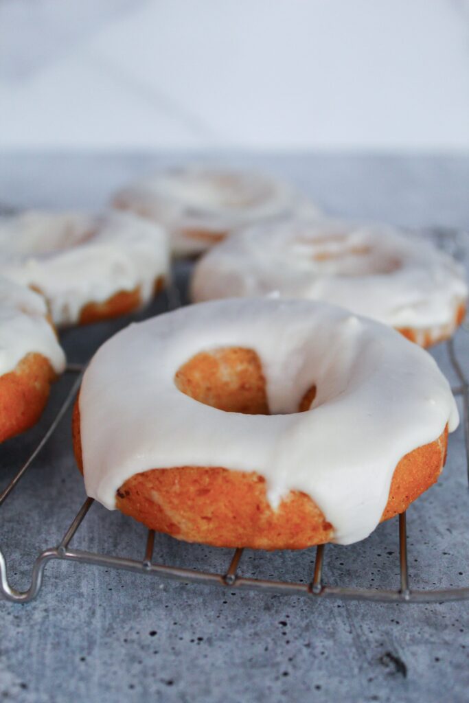 An absolutely decadent fall treat,  Keto Pumpkin Donuts are sugar free, grain free, gluten free, low carb, and keto.  They are baked in a donut pan, then frosted with a delicious glaze.