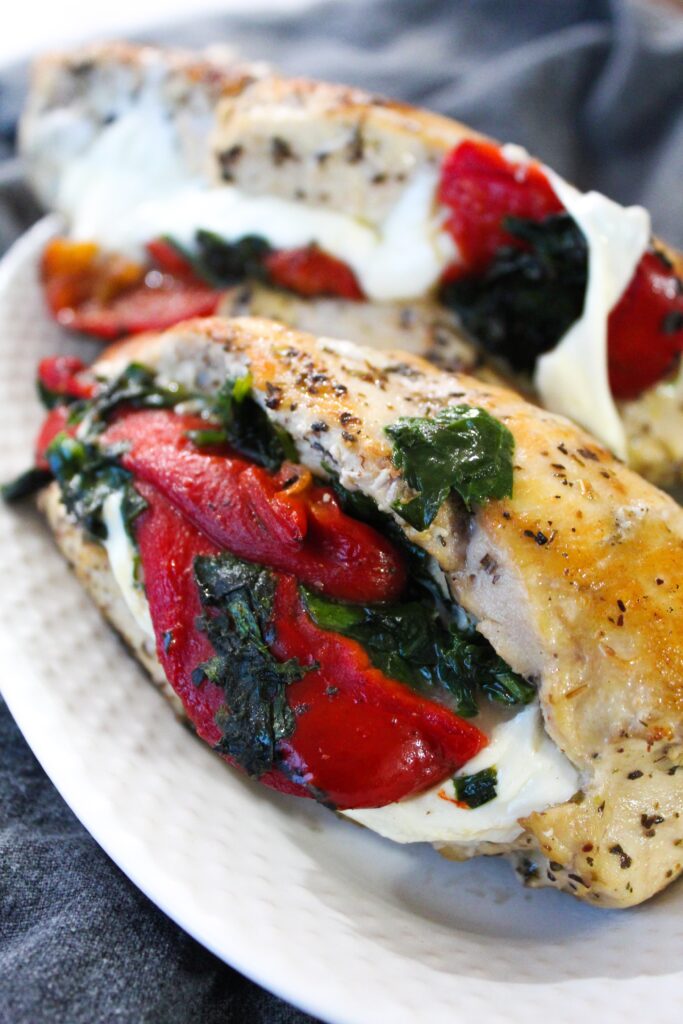 The combination of roasted red peppers, mozzarella, and spinach stuffed inside a chicken breast is one that pretty much everyone enjoys.  It evokes old school italian flavors, and is bursting with flavor!