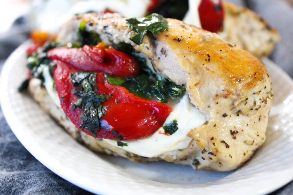 The combination of roasted red peppers, mozzarella, and spinach stuffed inside a chicken breast is one that pretty much everyone enjoys.  It evokes old school italian flavors, and is bursting with flavor!