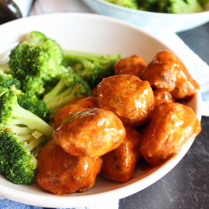 Keto Chicken Meatballs with Sweet and Sour Sauce are the perfect family meal.  Versatile enough to re-purpose into many different meals, moist, and easy to make, Keto Chicken Meatballs are a staple in our house!