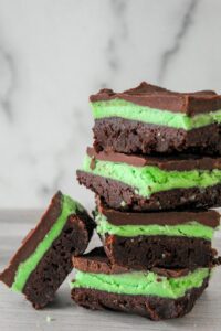 Thick, fudgy keto brownies layered with fluffy mint frosting and a chocolate fudge topping.  These Keto Chocolate Mint Brownies will blow your mind whether you make them from a mix or from scratch.