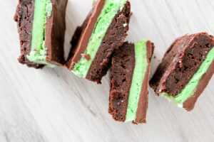 Thick, fudgy keto brownies layered with fluffy mint frosting and a chocolate fudge topping.  These Keto Chocolate Mint Brownies will blow your mind whether you make them from a mix or from scratch.