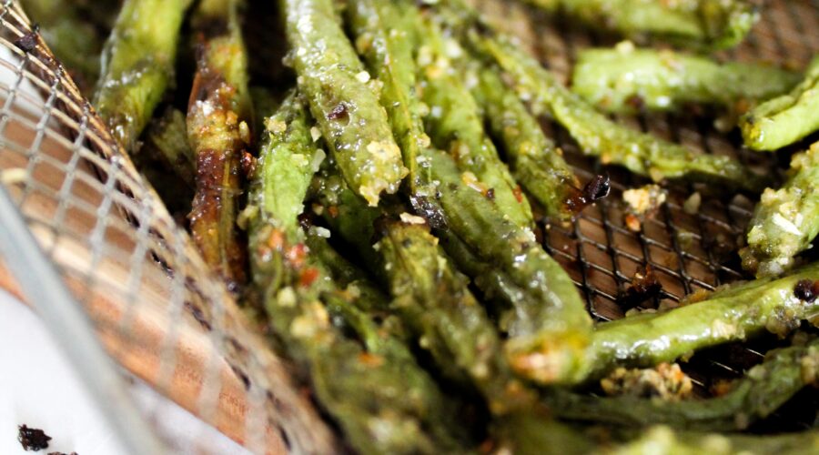 Green beans roasted in the oven take a long time and heat up the house, but Air Fryer Green Beans take less time, are crispy, and don't heat up the house.  They're very easy to make and are an excellent side dish that you can use many different herb combinations on!
