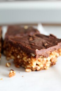 Keto Scotcheroos are a chewy no-bake peanut butter rice krispie bar with a butterscotch chocolate topping. My version is low carb, high protein, ketogenic, and a THM:S.