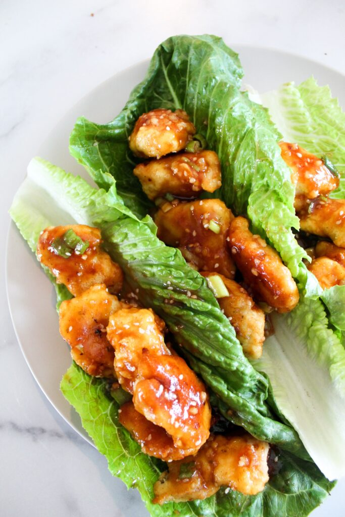 Keto Sesame Chicken is a low carb take on an Asian takeout classic.  Battered and air fried (or fried) chicken pieces coated in a sesame sauce made low carb, ketogenic, paleo, sugar free, grain free, and a THM:S