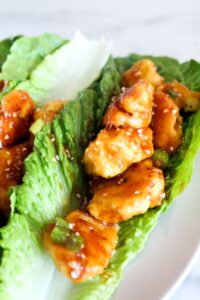 Keto Sesame Chicken is a low carb take on an Asian takeout classic.  Battered and air fried (or fried) chicken pieces coated in a sesame sauce made low carb, ketogenic, paleo, sugar free, grain free, and a THM:S