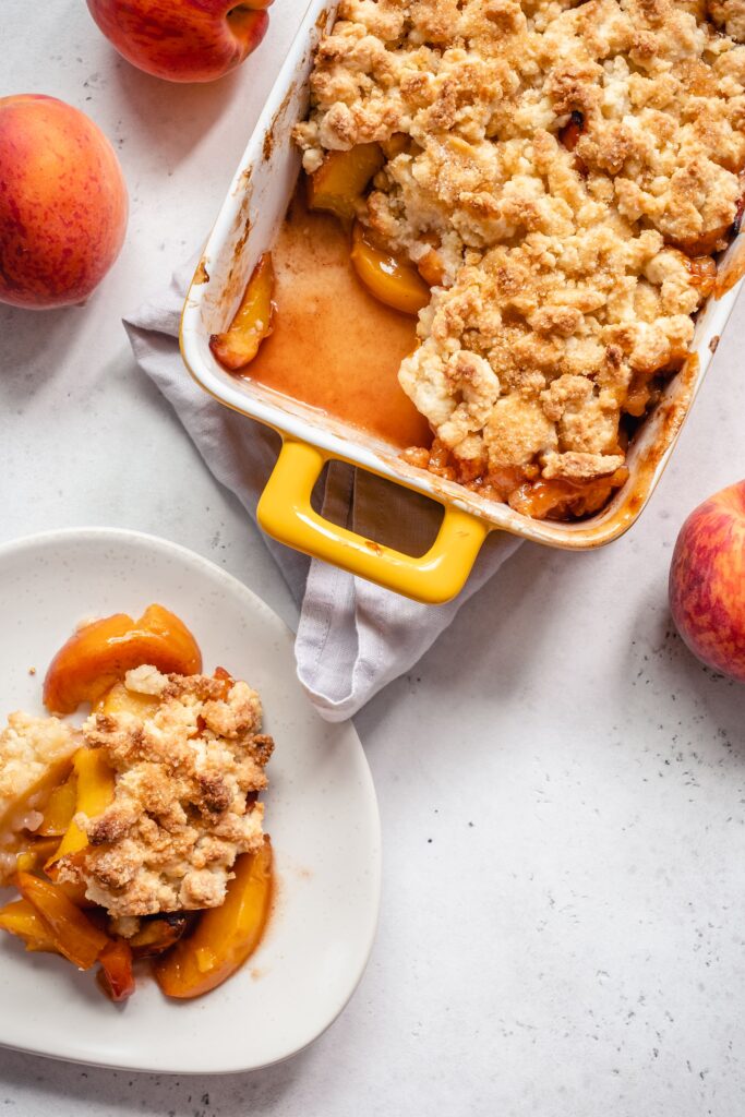 A healthy keto peach cobbler that is made grain free, gluten free, sugar free, ketogenic, and more!  Use fresh, in-season peaches for a delicious dessert that's perfect with a scoop of keto ice cream.
