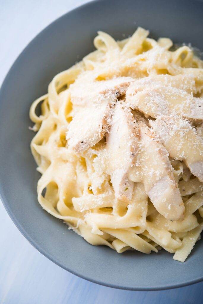 Creamy homemade Keto Alfredo Sauce made from garlic, parmesan, and cream.  The sauce is very easy to make low carb or Ketogenic - and tastes so much better than pre-made from the store.