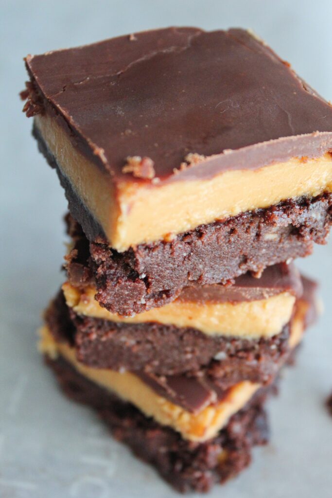 Buckeyes are a candy made from peanut butter fudge dipped in melted chocolate - so delicious!  These Keto Peanut Butter Brownies are inspired by the classic buckeye treat, using a base of chocolate brownies, topped with peanut butter fudge, followed by a layer of melted chocolate.