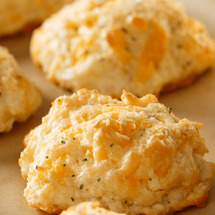 Super easy Keto Cheddar Biscuits that are fluffy and a copycat recipe to a popular restaurant chain.  Garlicy, butter, and delicious, these biscuits are the perfect simple side.