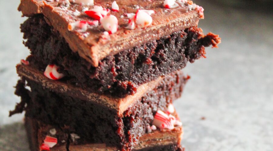 Classic Keto Fudge Brownies with peppermint extract and mint chocolate chips.  These Keto Peppermint Brownies are topped with fudge icing and crushed candy canes.