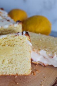 This moist Keto Lemon Loaf is fluffy, tangy & sweet, and very easy to make.  It requires not special ingredients but still hangs onto the flavor and texture of certain chain's beloved lemon loaf that goes so well with coffee.  Top it with a sweet lemon glaze for a delicious treat!