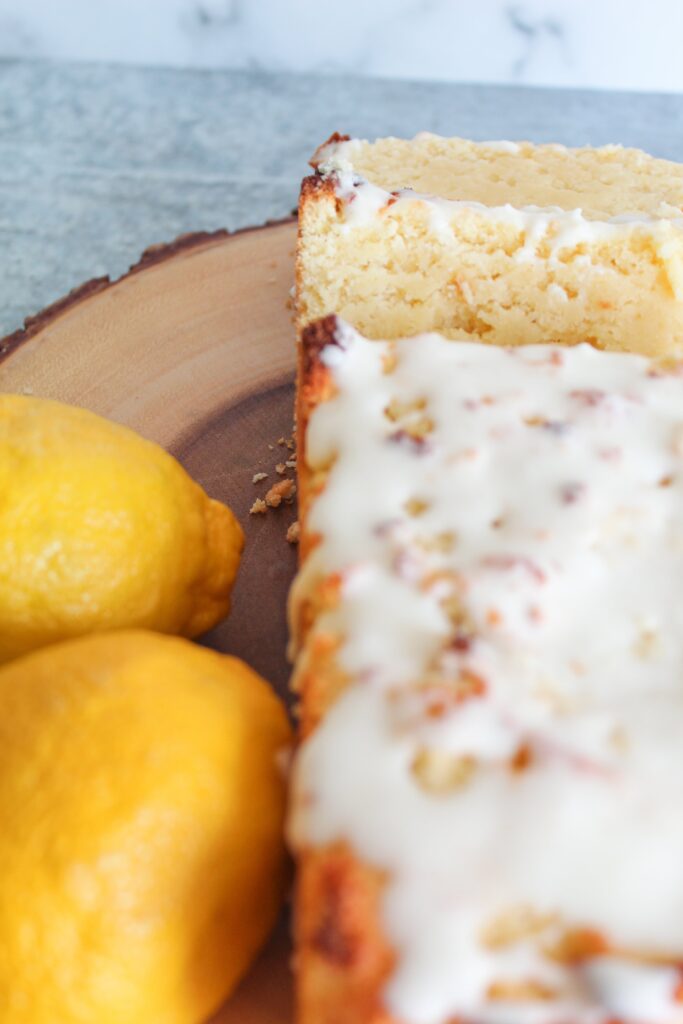 This moist Keto Lemon Loaf is fluffy, tangy & sweet, and very easy to make.  It requires no special ingredients but still hangs onto the flavor and texture of certain chain's beloved lemon loaf that goes so well with coffee.  Top it with a sweet lemon glaze for a delicious treat!