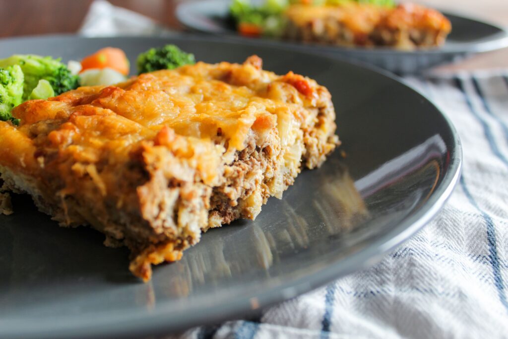 Keto Bacon Cheeseburger Casserole is a quick-prep dinner that I love to make ahead, freeze, and reheat for busy days or meal portioning.  Made with inexpensive ground beef, eggs, cheese, and a sauce that tastes exactly like a cheeseburger, it's a convenient burger without the bun!