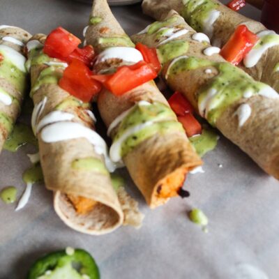 Easy, homemade Keto Chicken Taquitos made with shredded chicken, fresh salsa, and cheddar cheese rolled in a low carb tortilla and baked until crispy.