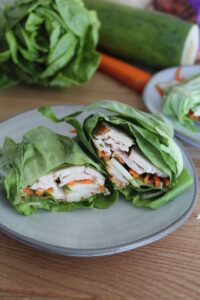 These easy Keto Thai Chicken Lettuce Wraps feature a spicy peanut sauce, crunchy cucumbers, and seasoned chicken all wrapped in crispy lettuce!  Feel free to swap out the lettuce for store-bought low carb wraps if you wish.