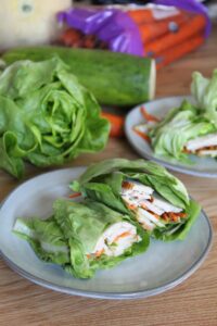 These easy Keto Thai Chicken Lettuce Wraps feature a spicy peanut sauce, crunchy cucumbers, and seasoned chicken all wrapped in crispy lettuce!  Feel free to swap out the lettuce for store-bought low carb wraps if you wish.