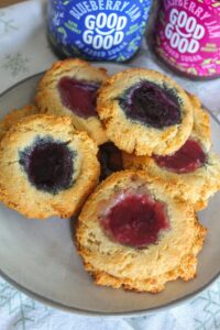 Soft shortbread cookies with a center of raspberry, blueberry, or apricot jam are Keto Thumbprint Cookie perfection.  A classic holiday treat!