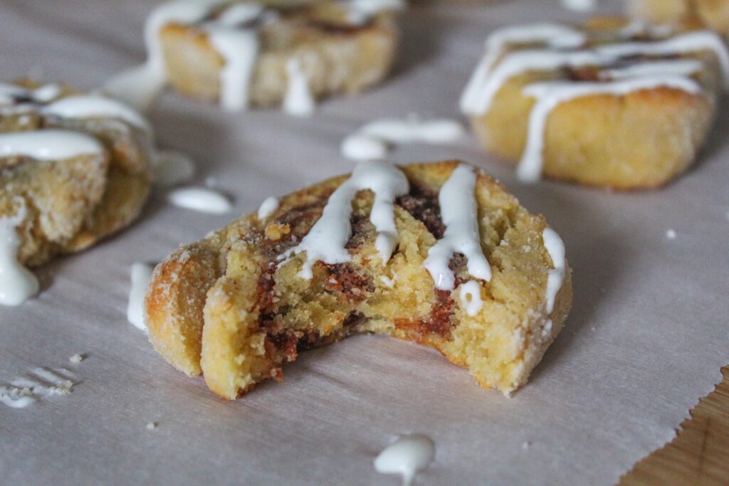 Keto Cinnamon Roll cookies are one of my favorite ways to repurpose keto sugar cookies into something cool!  Roll up the dough with a buttery sweet cinnamon filling, bake, and drizzle with vanilla icing.  The soft centers and slightly crisp outers mimic yeast cinnamon rolls - but without all the carbs and sugars!