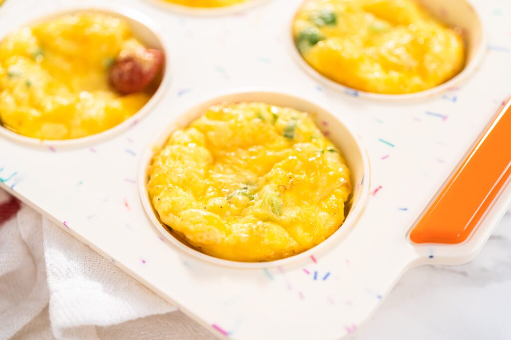 Keto Egg Muffins are a big batch meal prep recipe you can make once and eat during busy mornings all week! These are made using ham and cheese, but the options are endless. Low Carb, Ketogenic, THM:S, Sugar Free, and Grain Free.