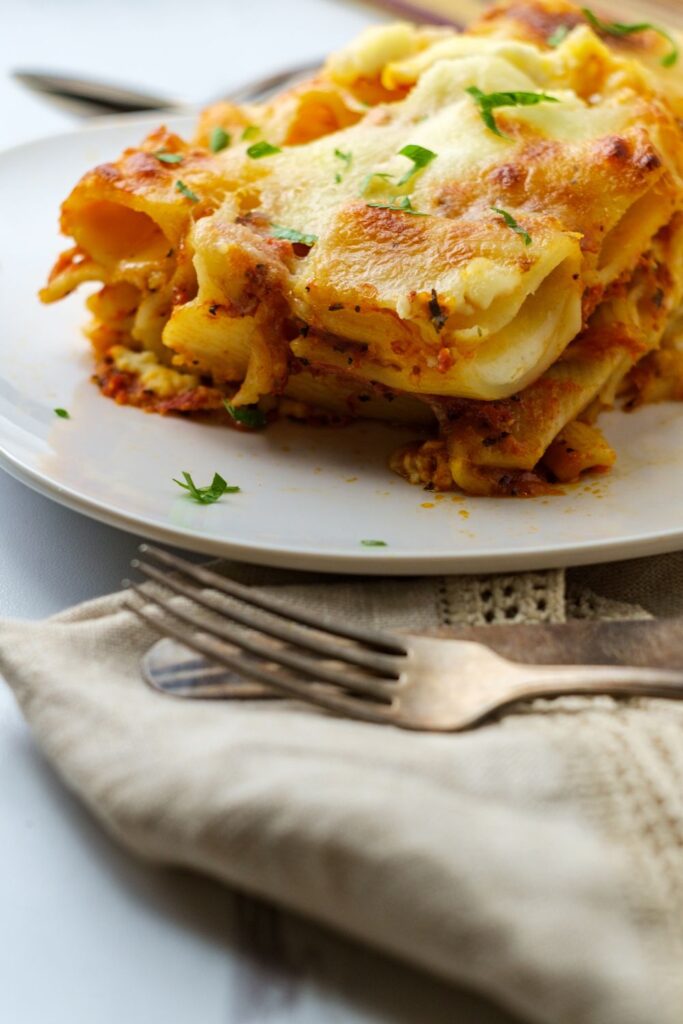 Keto baked ziti is a low carb twist on a classic recipe. You'll love how hearty and cheesy this comfort food dish is. Made with meat sauce, low carb noodles, and sugar free marinara, this is one of our favorite recipes for it's cheesy goodness!