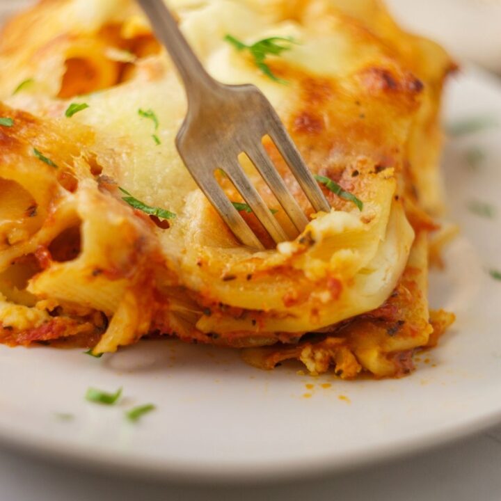 Keto baked ziti is a low carb twist on a classic recipe. You'll love how hearty and cheesy this comfort food dish is. Made with meat sauce, low carb noodles, and sugar free marinara, this is one of our favorite recipes for it's cheesy goodness!